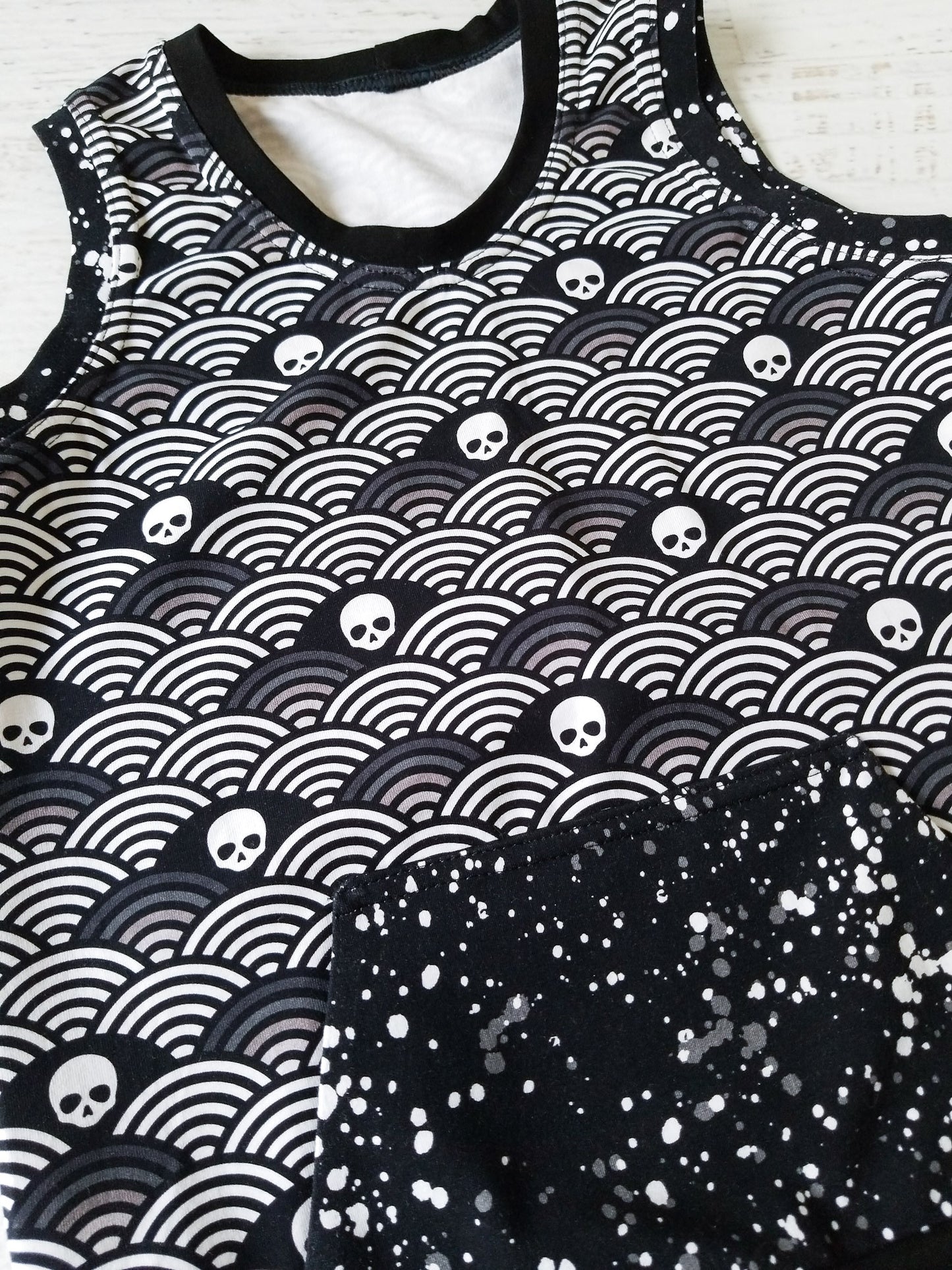 Monochrome skulls and rainbows tank, front pocket, size 8